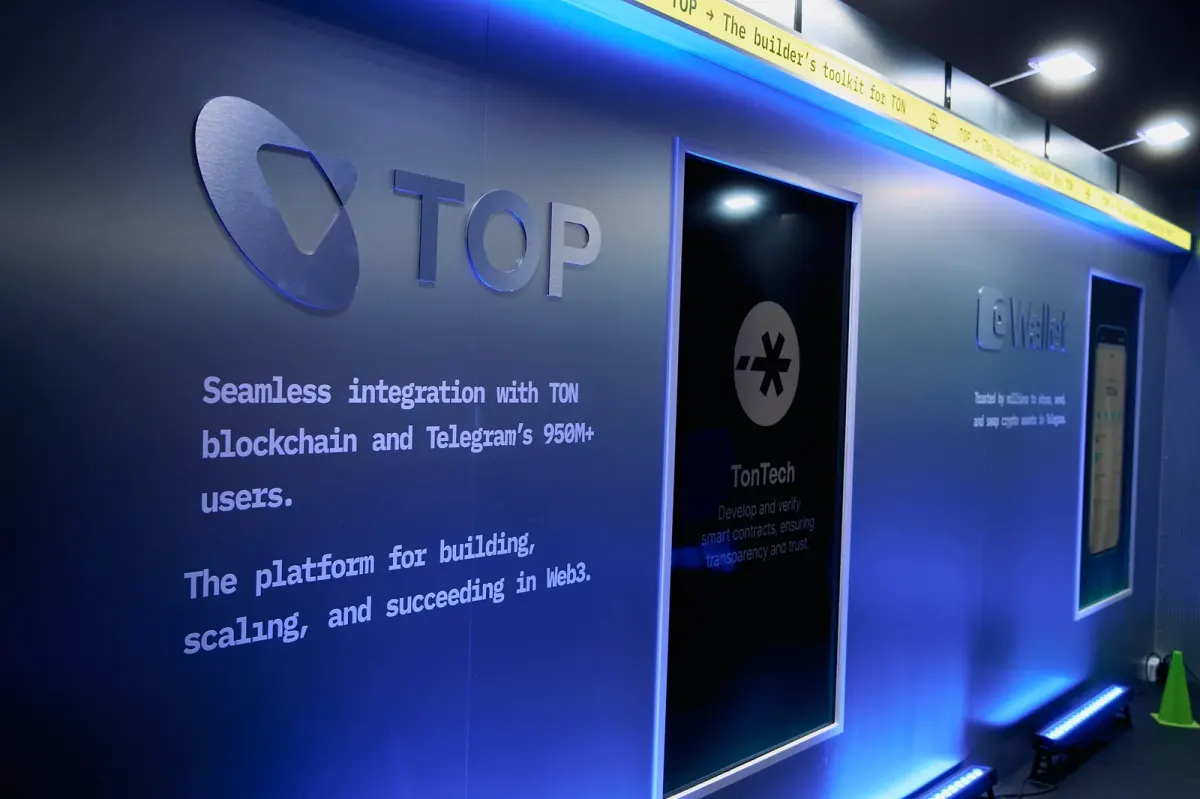 Conference event screen with partially readable blockchain and Telegram text in Dubai